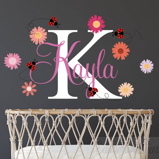 Custom name wall sticker featuring pink daisy flowers and cute ladybugs