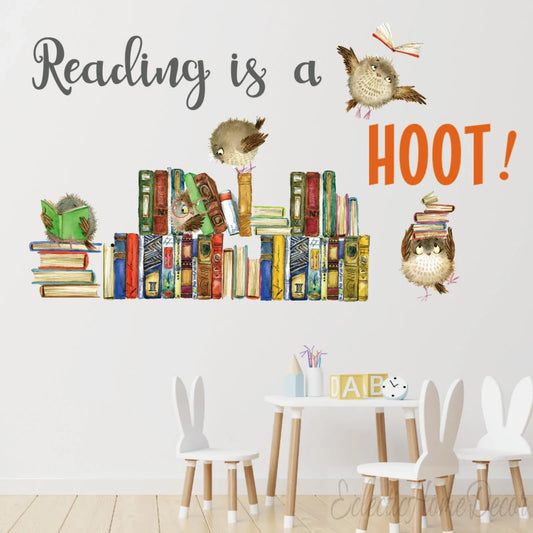 Kids reading nook with playful owl and book decals, 'Reading is a hoot!' wall sticker by YKLT Decals.