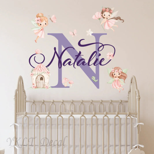 Personalized fairy-themed wall decal with 'Natalie' above a crib, custom kids room decor