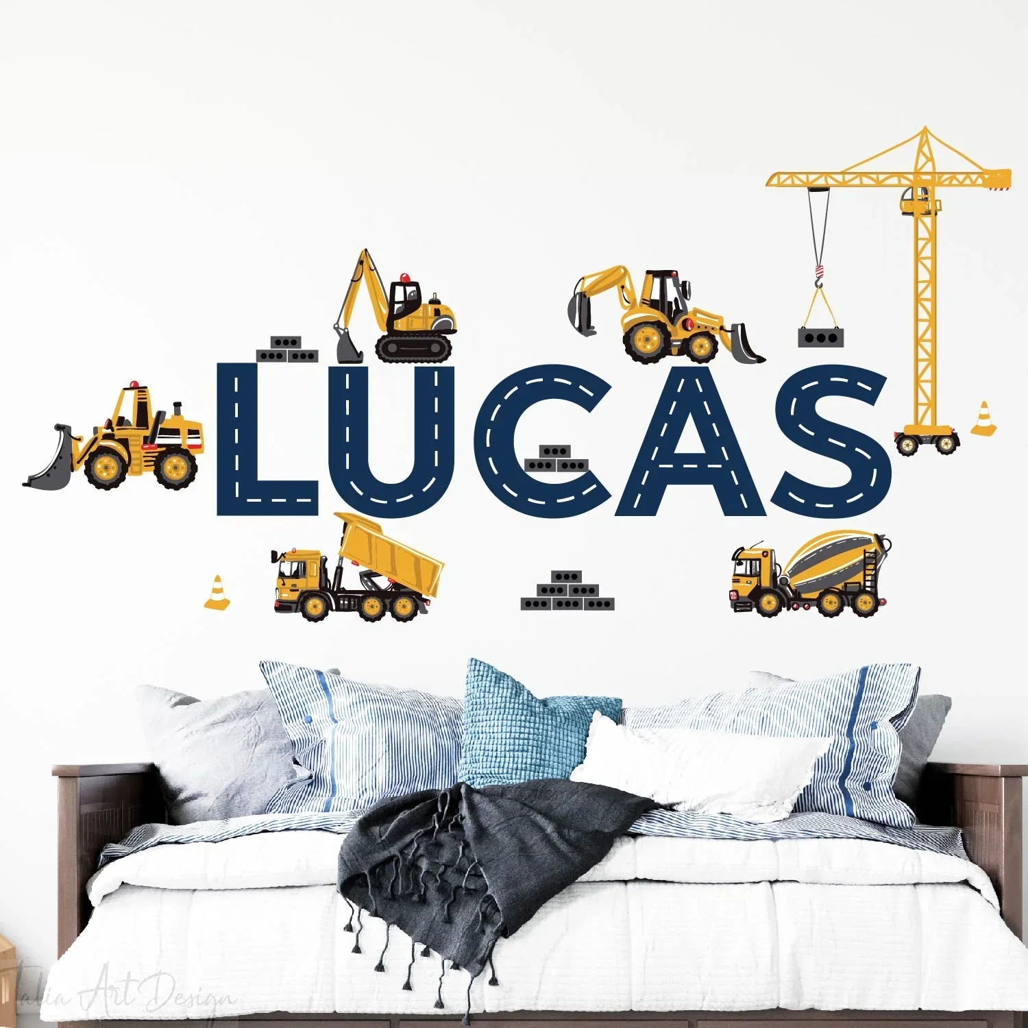 Personalized kids room wall decal with construction trucks and 'Lucas' name above bed