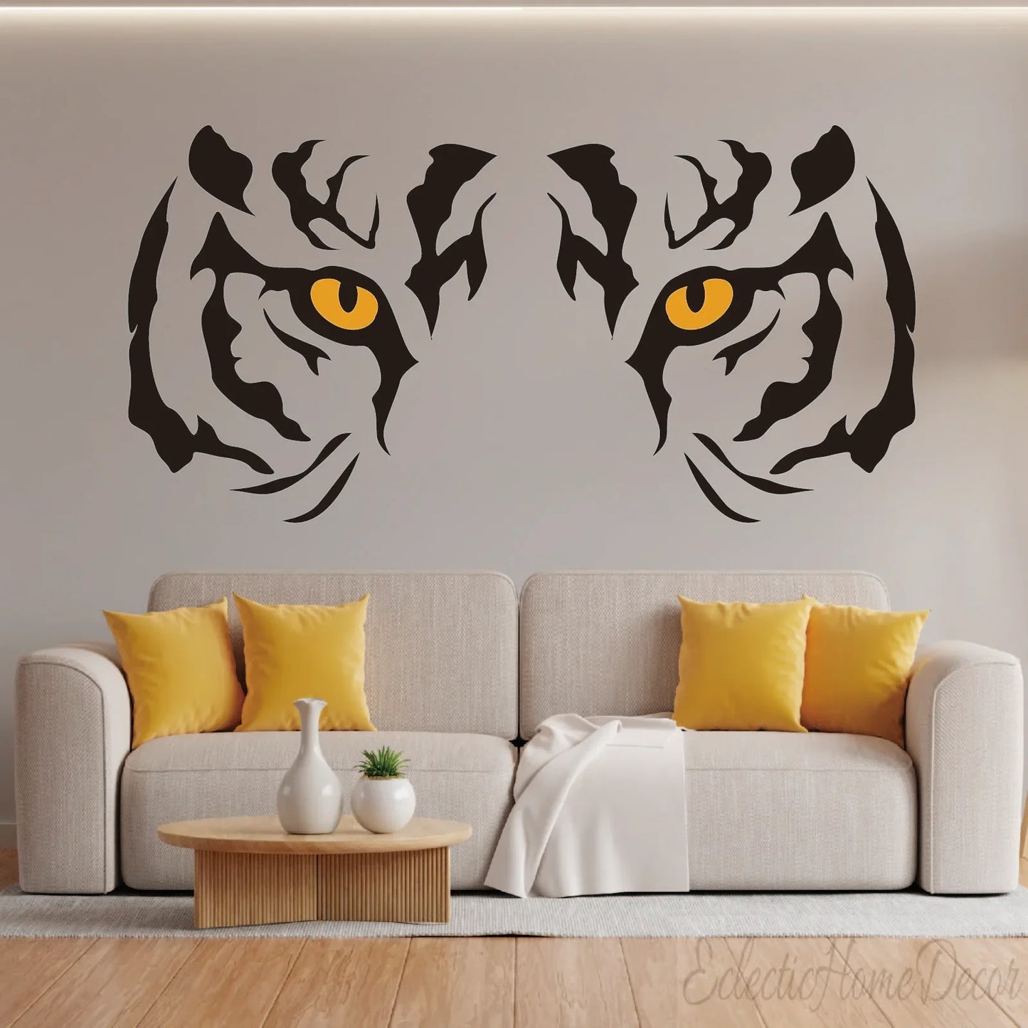 Tiger eyes wall decal above beige sofa with yellow pillows, modern living room decor by YKLT Decals
