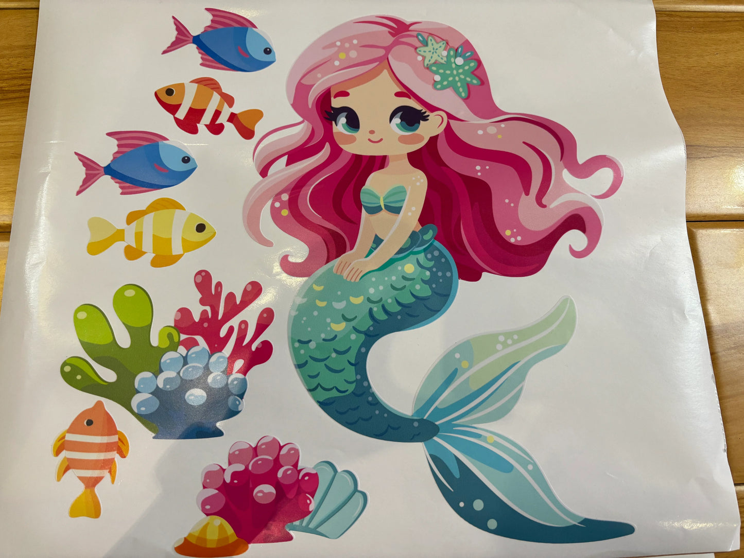 Colorful mermaid wall decal with fish and coral, perfect for kids room decor by YKLT Decals