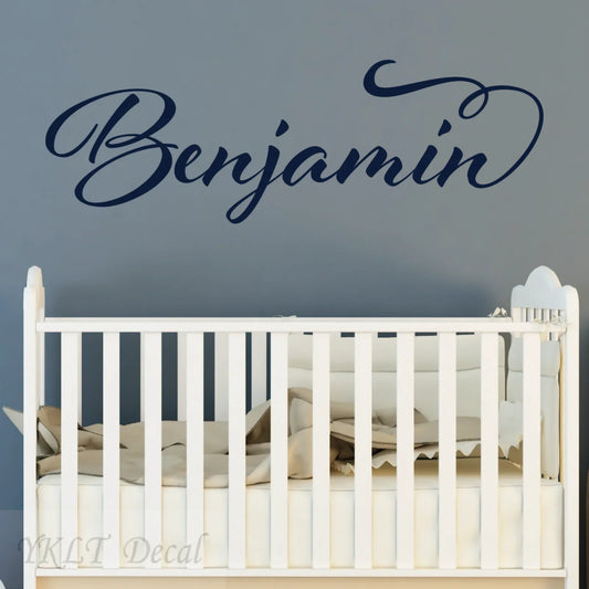 Custom name wall decal reading 'Benjamin' above baby crib, nursery decor by YKLT Decals