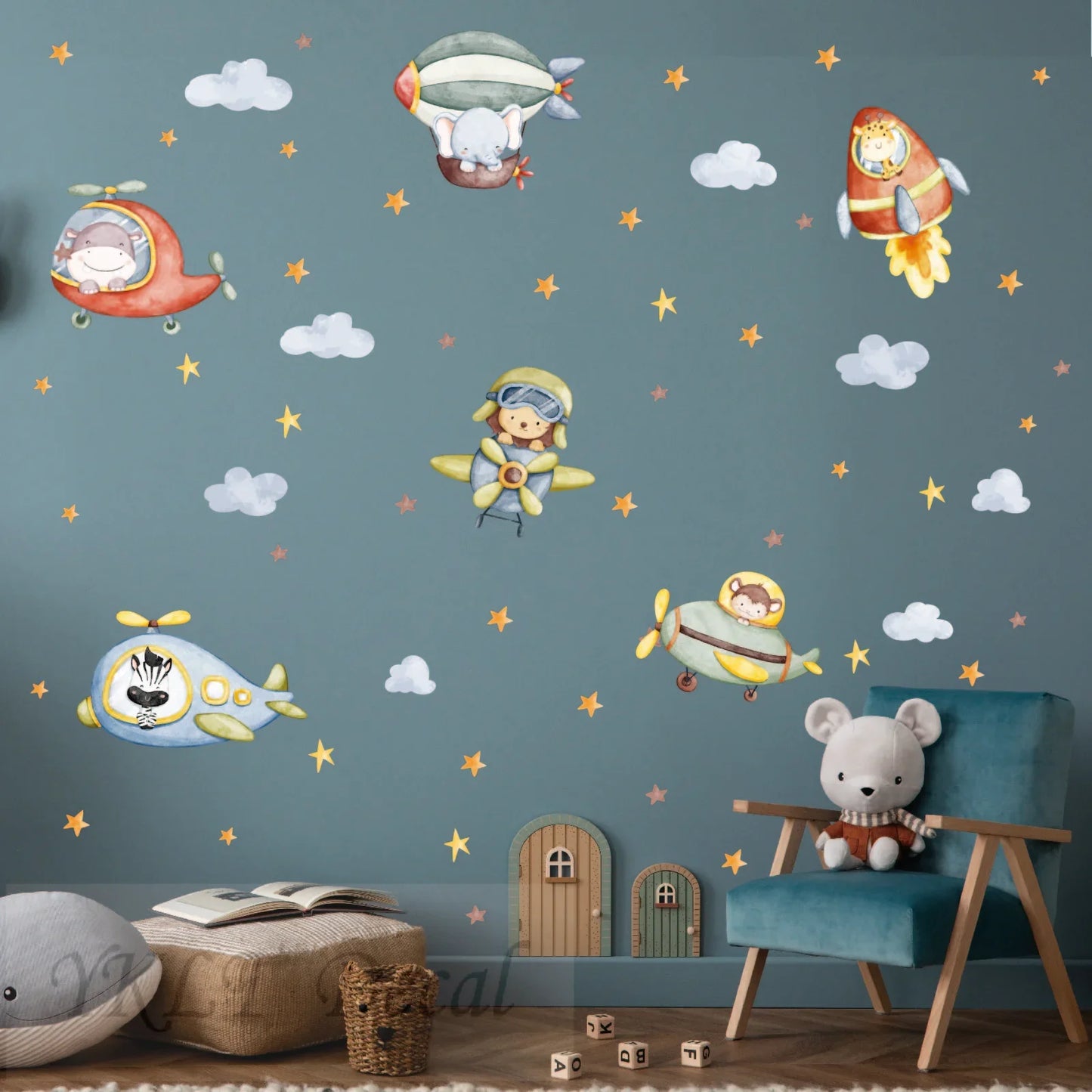 Whimsical kids room with YKLT Decals featuring animal pilots, airplanes, rockets, and stars on blue wall